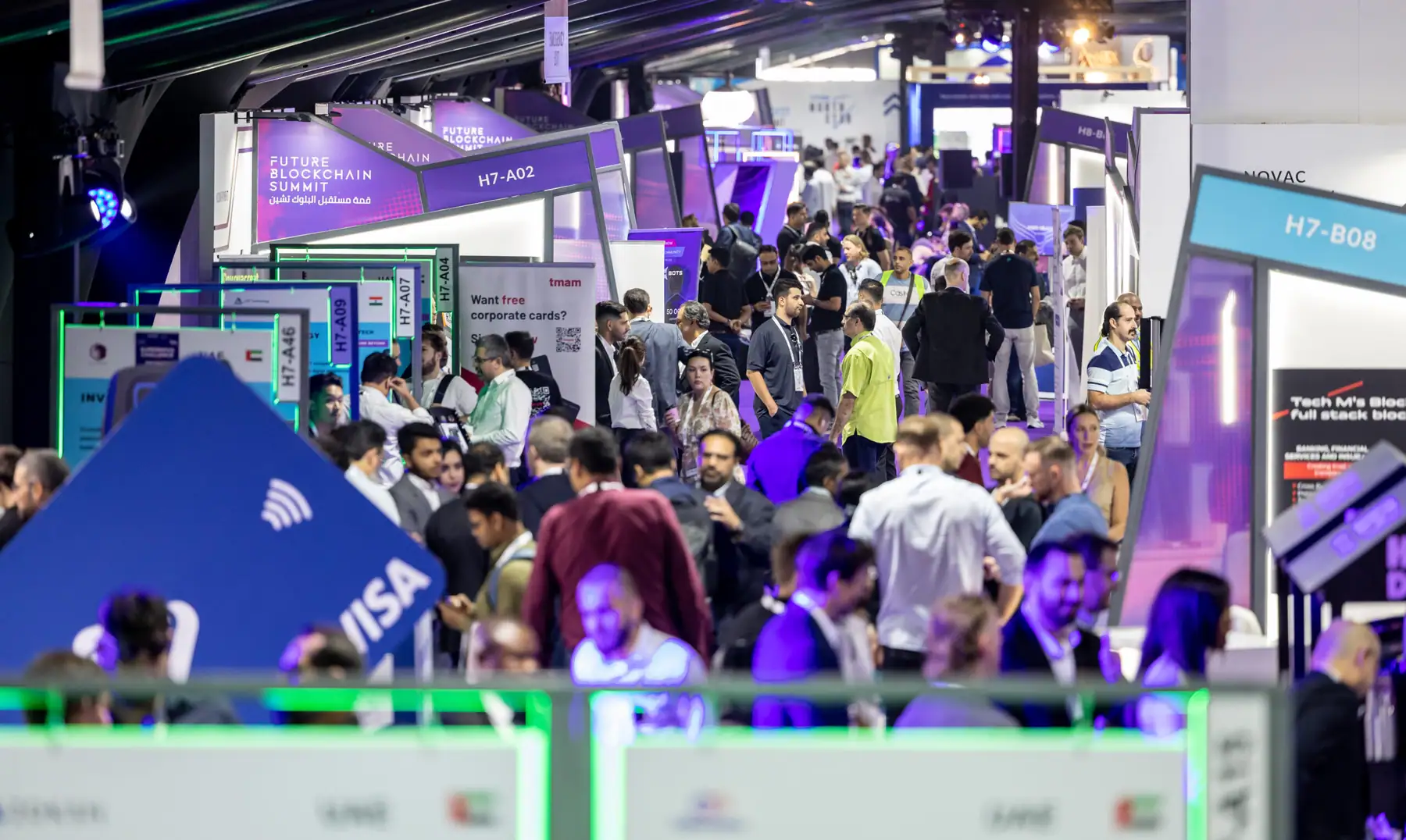 Visitors moving between exhibitor stands in a GITEX Global hall